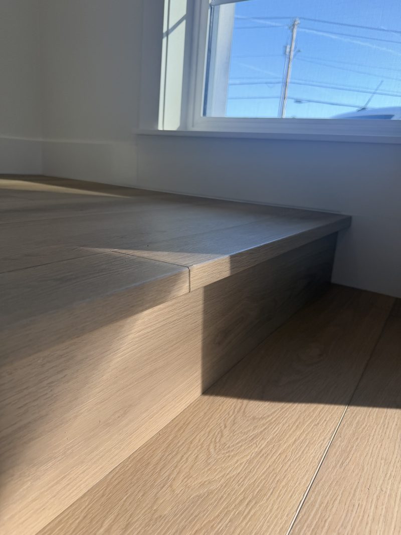 Light hardwood with window-seat platform and matching trim