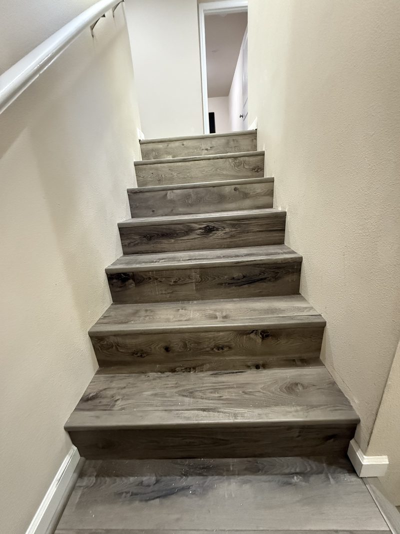 Luxury vinyl plank staircase with matching treads and risers
